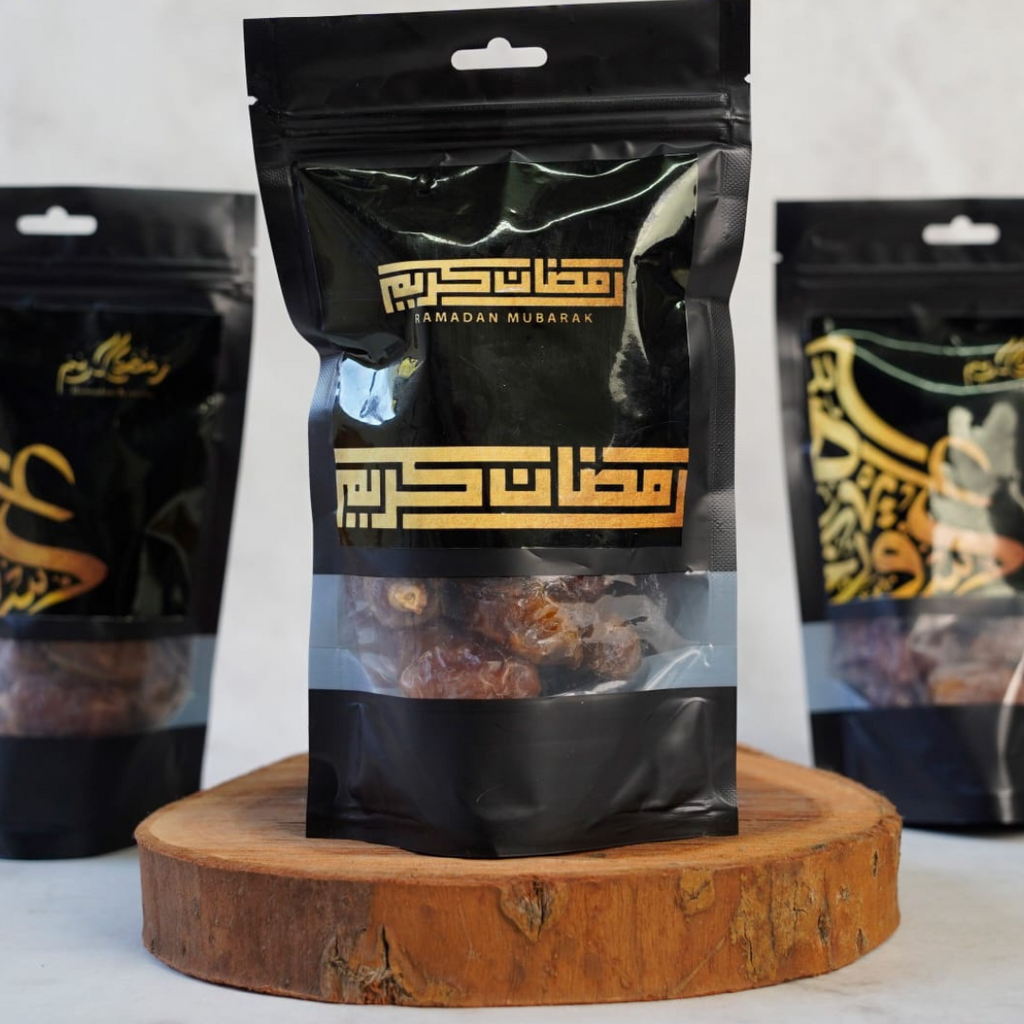 Black snack bag with gold text on a wooden stand, featuring 'Snack Dash' brand.