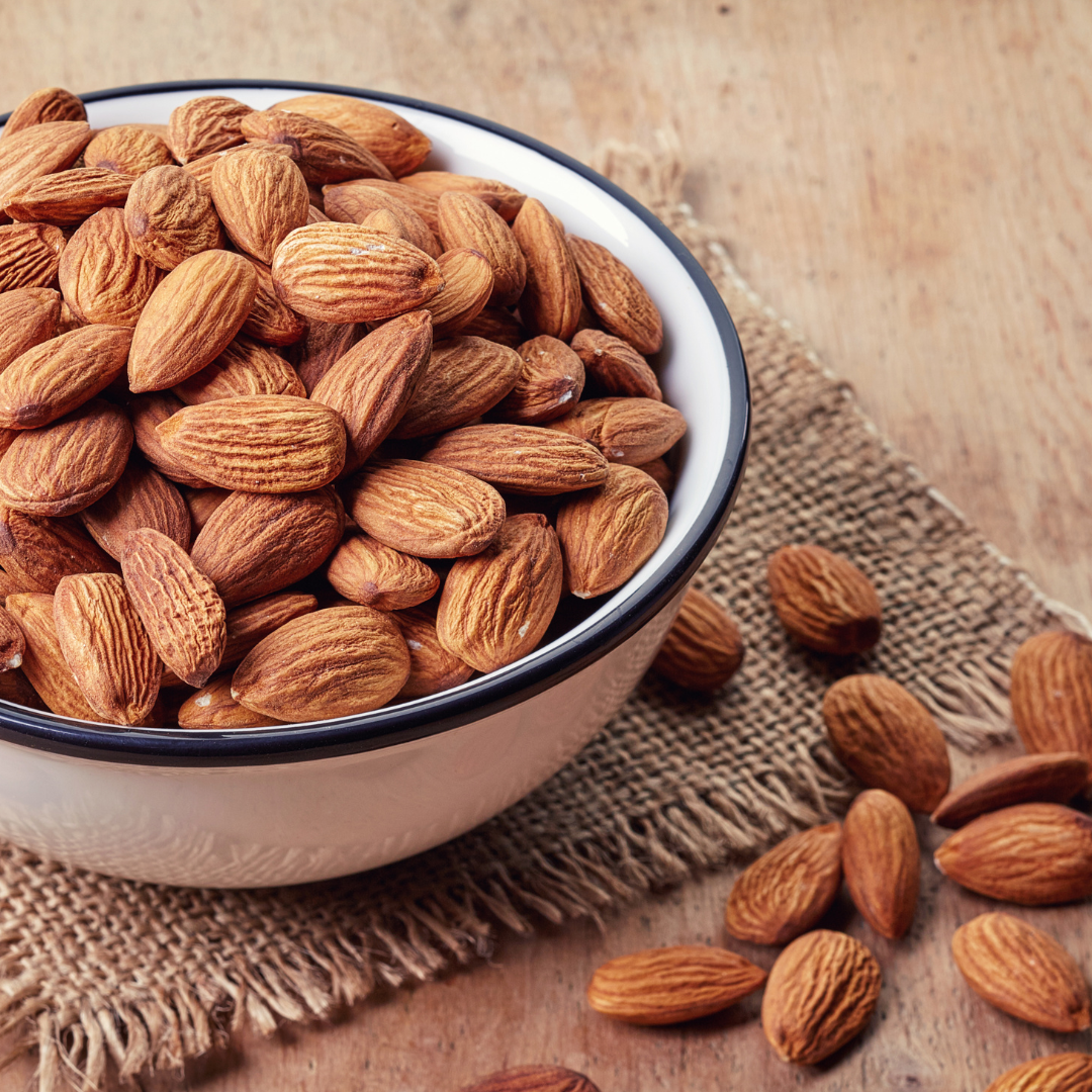 Bowl of almonds on a wooden surface