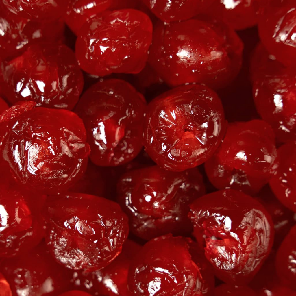 Close-up of red dried fruits with 'Snack N Dash' logo.