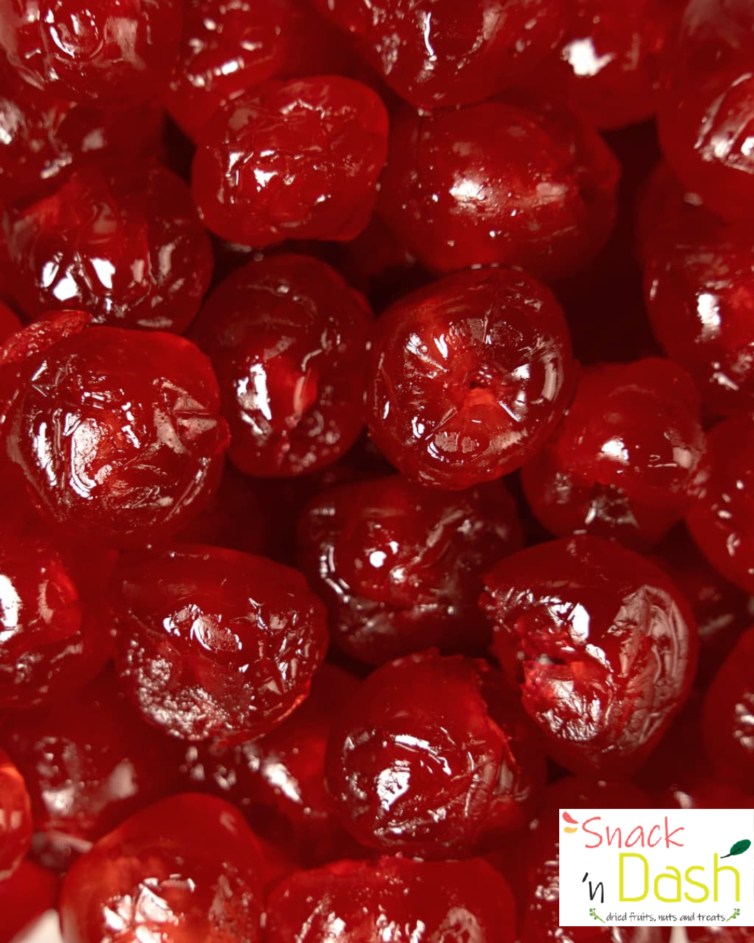 Close-up of red dried fruits with 'Snack N Dash' logo.