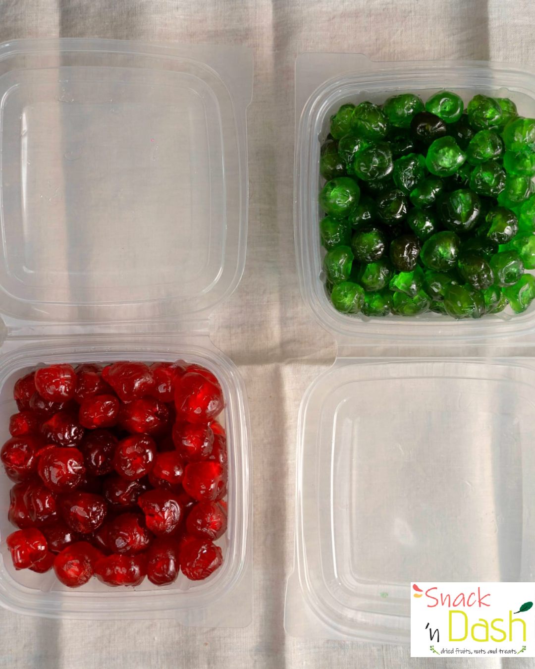 Two containers with red and green gummy bears on a textured surface, branded 'Snack Dash'.
